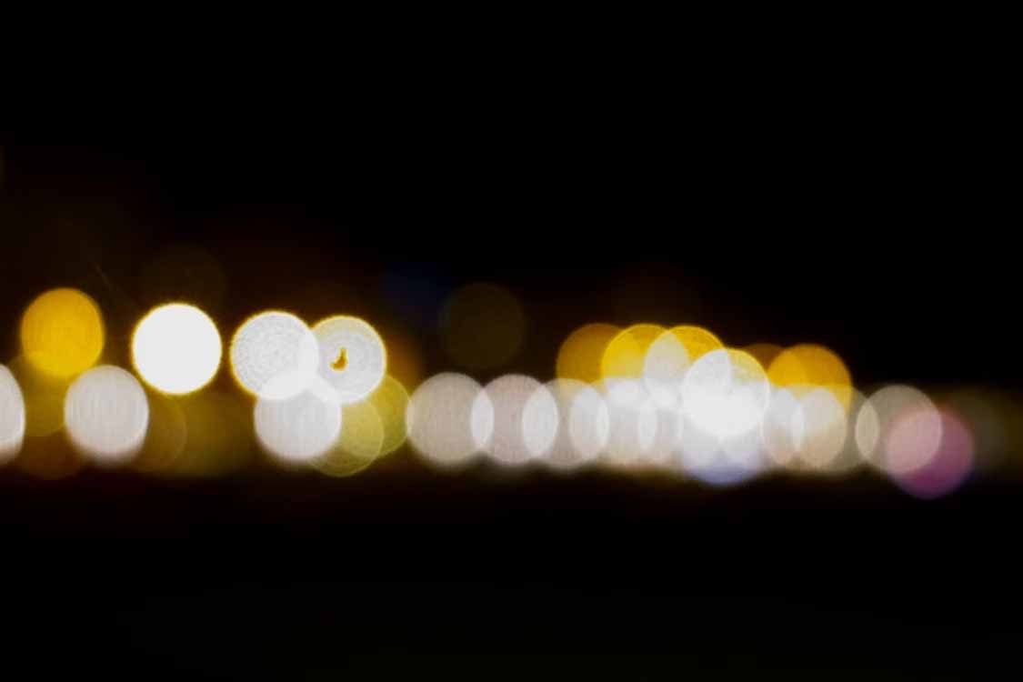 Out of focus row of warm and cool light points showing the dotting effect caused by low LED density in display lighting Out of focus row of warm and cool light points showing the dotting effect caused by low LED density in display lighting